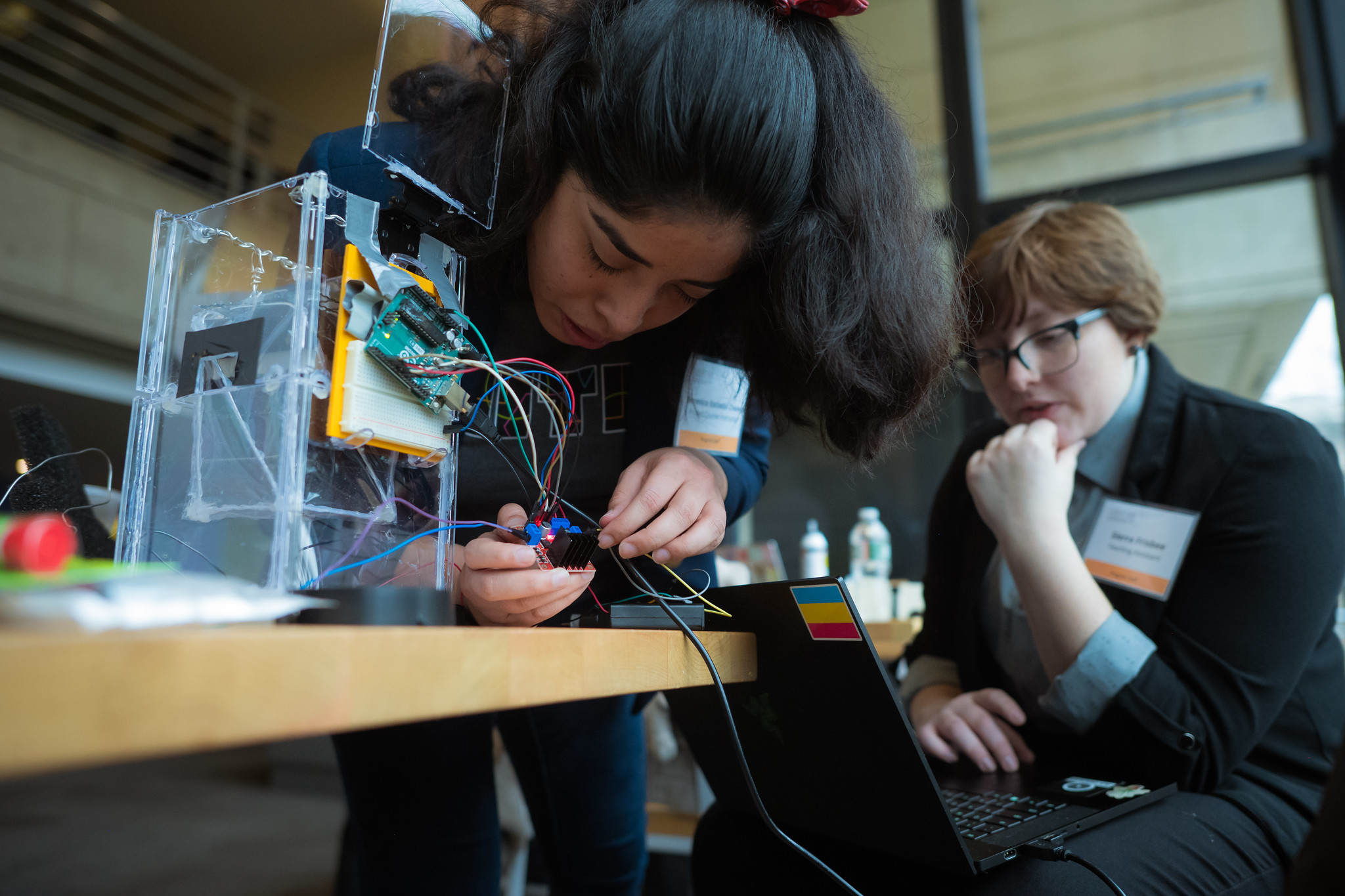 MITES instructor adjusts cables in a box